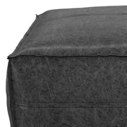 Large square Brody coffee table pouf by Simpli-Home, beige fabric accent pouf on a living room floor.