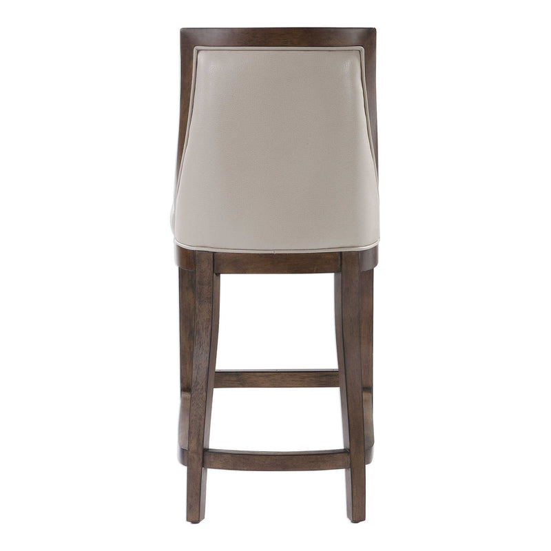 Uttermost Purcell beige counter stool with a cushioned seat and wooden legs, designed for counter height seating.