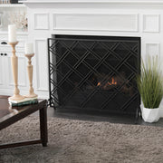 Noble House elegant fireplace screen with intricate metal design, serving as a protective barrier for a home hearth.
