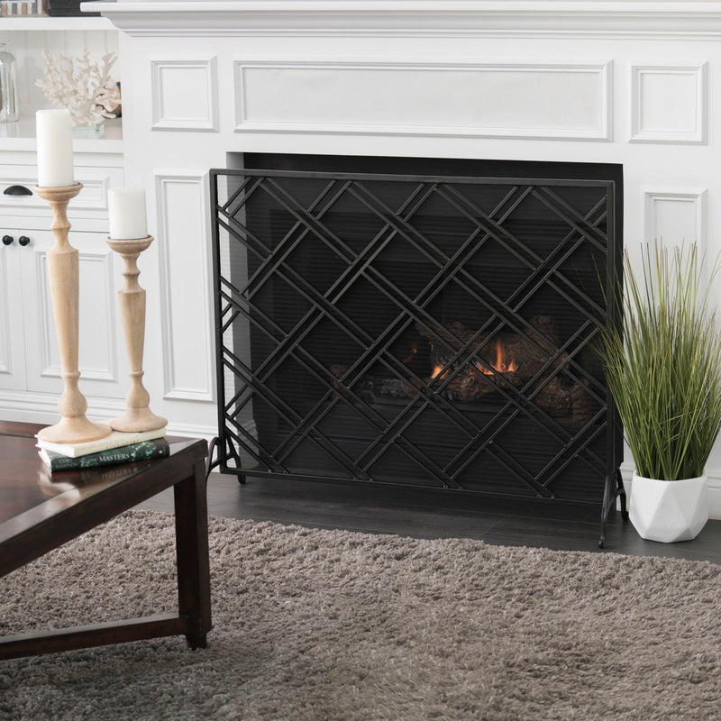 Noble House elegant fireplace screen with intricate metal design, serving as a protective barrier for a home hearth.