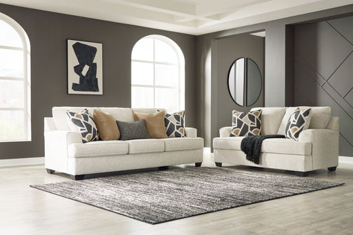Benchcraft® Heartcort living room set with stationary chair and matching ottoman, featuring plush upholstery and modern design.