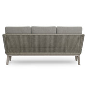 Simpli-Home Carmel outdoor sofa in Sand Drift with beige cushions on a patio setting, perfect for outdoor lounging.