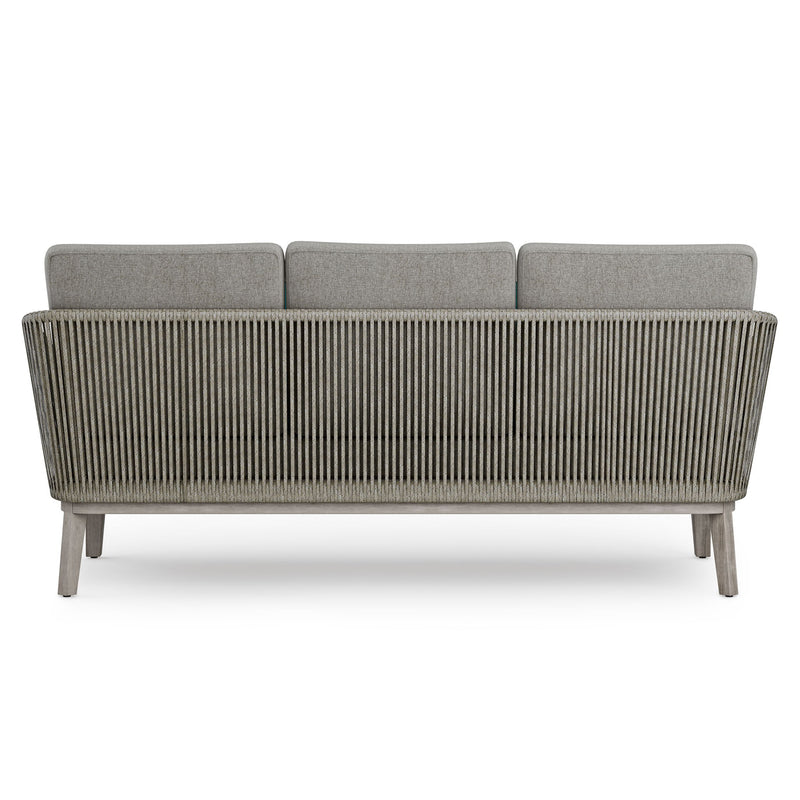 Simpli-Home Carmel outdoor sofa in Sand Drift with beige cushions on a patio setting, perfect for outdoor lounging.
