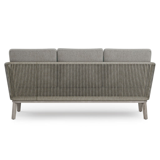 Simpli-Home Carmel outdoor sofa in Sand Drift with beige cushions on a patio setting, perfect for outdoor lounging.