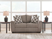 Benchcraft® Loreo stationary loveseat with plush fabric and cushioned armrests, ideal for cozy living room seating.