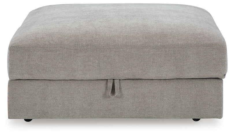 Benchcraft® Aslan Court 5-piece sectional with ottoman set in a modern living room, featuring plush cushions and stylish design.