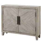 White washed Adalind Accent Cabinet by Uttermost, featuring a rustic wooden design with storage drawers and a distressed finish.