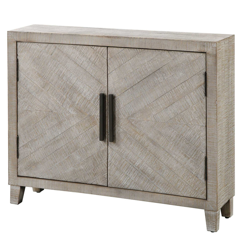 White washed Adalind Accent Cabinet by Uttermost, featuring a rustic wooden design with storage drawers and a distressed finish.