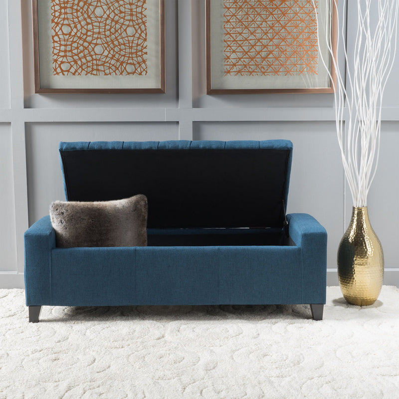Noble House Guernsey storage ottoman with tufted top, beige fabric, and sturdy wooden legs, serving as stylish bedroom or living room storage.