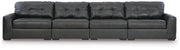 Signature Design by Ashley Brindley Pier sectional sofa with plush cushions and modern design in a spacious living room setting.
