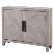 White washed Adalind accent cabinet by Uttermost with wood grain finish and decorative hardware, showcasing a stylish storage piece.