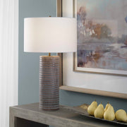 Gray Monolith table lamp by Uttermost featuring a sleek, modern design with a sturdy base and a fabric lampshade.