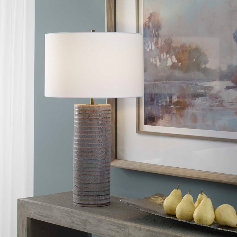 Gray Monolith table lamp by Uttermost featuring a sleek, modern design with a sturdy base and a fabric lampshade.
