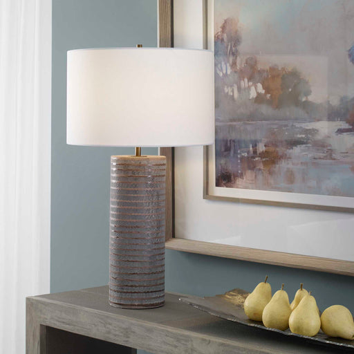Gray Monolith table lamp by Uttermost featuring a sleek, modern design with a sturdy base and a fabric lampshade.