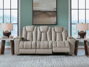 Signature Design by Ashley Elevate Edges reclining sofa with drop-down table in coin fabric, showcasing plush seating and built-in table feature.