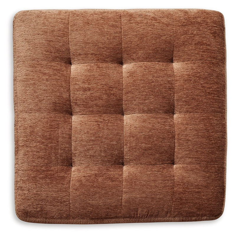 Ashley® Laylabrook oversized plush square accent ottoman in spice fabric with dark wood trim, showcasing a soft, cushioned surface.