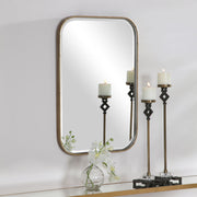 Gold Malay vanity mirror by Uttermost with a sleek, round frame and reflective glass for elegant home decor.