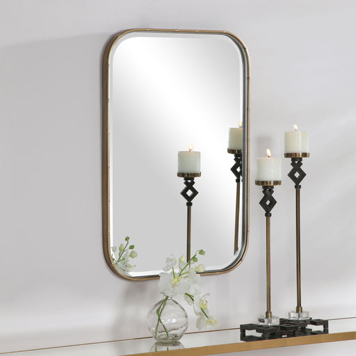 Gold Malay vanity mirror by Uttermost with a sleek, round frame and reflective glass for elegant home decor.