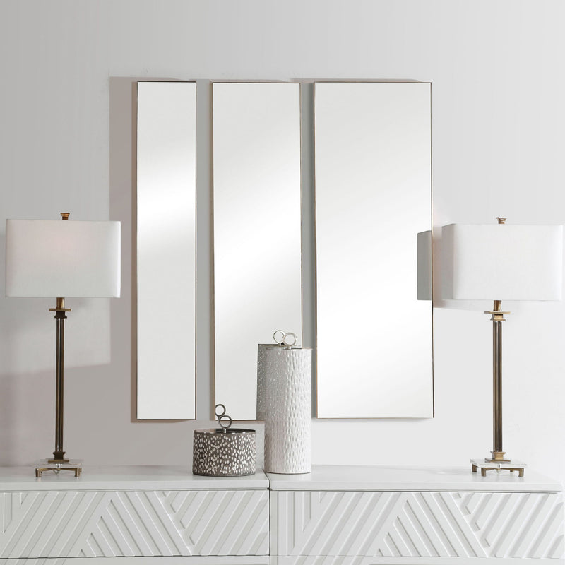Set of three gold wall mirrors by Uttermost featuring modern round designs for stylish home decor.