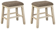 Set of two beige upholstered stools by Signature Design by Ashley, featuring cushioned seats and wooden legs.