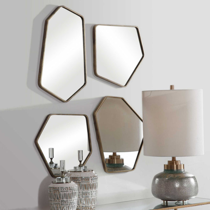 Set of four modern gold wall mirrors by Uttermost, featuring sleek frames and reflective surfaces for stylish home decor.