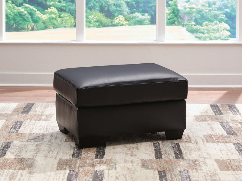 Signature Design by Ashley Glennbre Ottoman in midnight upholstered fabric, showing a modern, plush ottoman with tufted top.