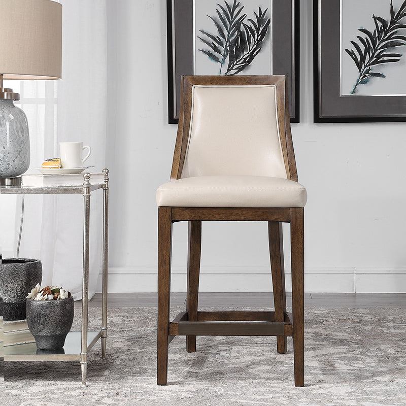 Uttermost Purcell beige counter stool with upholstered seat and wooden legs, designed for 24-27 inch counter height.