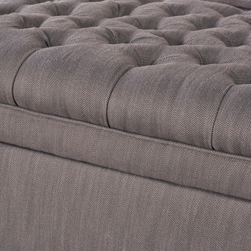 Noble House Juliana storage ottoman with birch wood legs, upholstered in neutral fabric, showing a cushioned top and storage space inside.