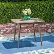 Modern indoor square acacia wood dining table with toothpick leg design by Noble House, showcasing a sleek, natural wood finish.