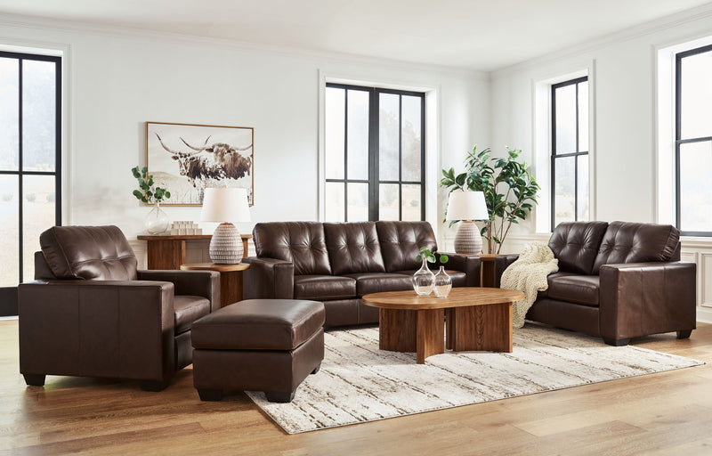 Signature Design by Ashley Santorine living room set with stationary chair and ottoman in a cozy, modern living space.