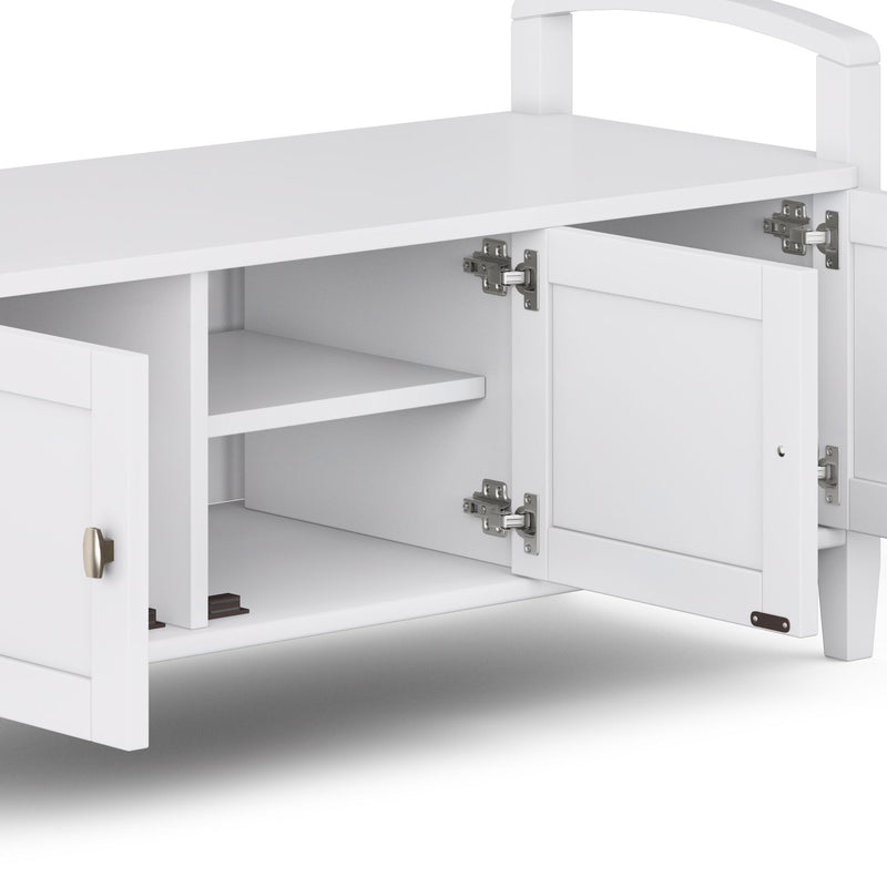 Handcrafted warm wood entryway storage bench by Simpli-Home with cushioned seat and built-in storage compartment.
