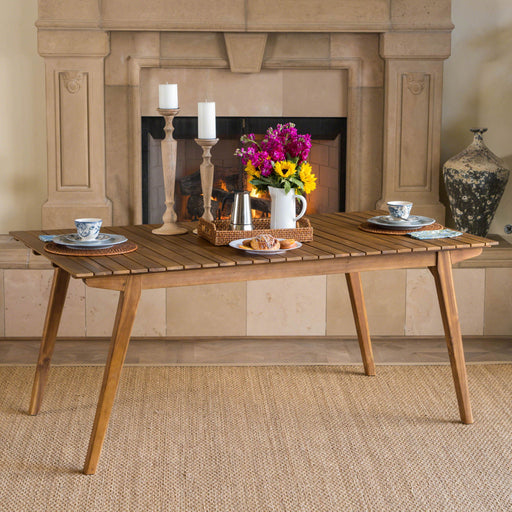 Outdoor teak dining table with sturdy frame by Noble House, featuring a spacious tabletop for outdoor dining and gatherings.