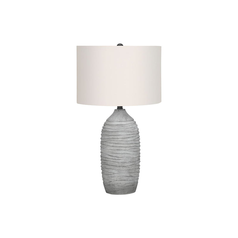 Modern gray and cream resin table lamp by 8th Street with sleek, contemporary design and soft lighting.