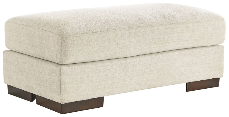 Signature Design by Ashley Maggie upholstered ottoman with plush fabric and wooden legs, versatile for living room or bedroom decor.