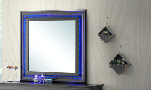 Metallic black mirror by Glory Furniture with a sleek modern frame, hanging on a wall.