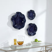 Set of three ceramic wall decor pieces by Uttermost, featuring modern abstract designs for stylish interior decoration.