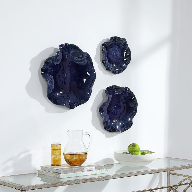 Set of three ceramic wall decor pieces by Uttermost, featuring modern abstract designs for stylish interior decoration.