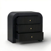 TOV Furniture Hump bedside chest with storage drawer and wooden finish, placed beside a bed in a modern bedroom setting.