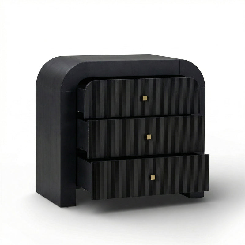 TOV Furniture Hump bedside chest with storage drawer and wooden finish, placed beside a bed in a modern bedroom setting.