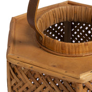 TOV Furniture Andi Rattan Lantern with woven rattan design, featuring a cylindrical shape and handle for decorative outdoor or indoor lighting