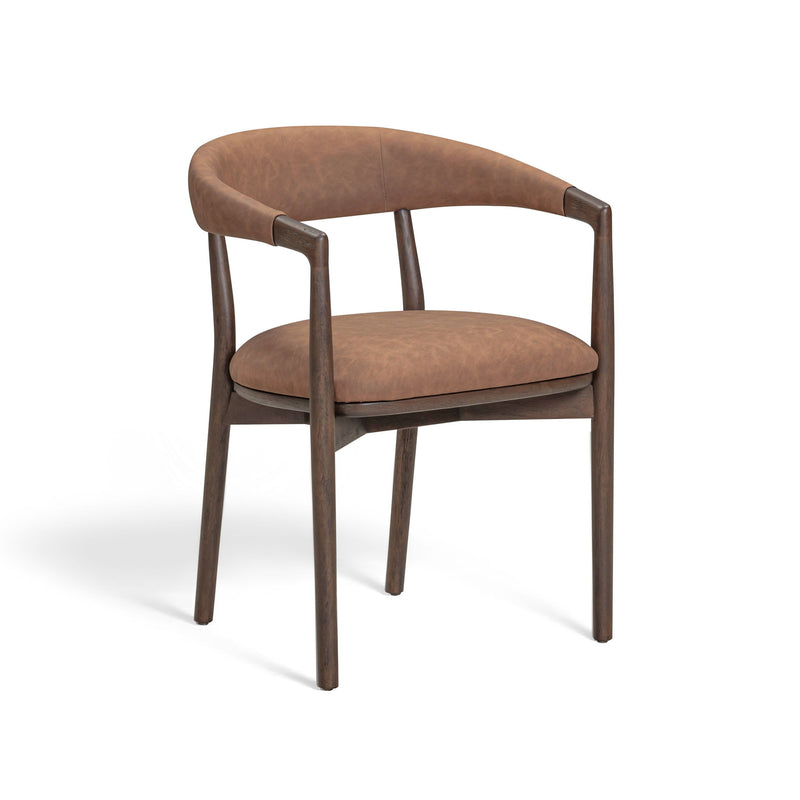 Vina vegan leather dining arm chair by TOV Furniture with sleek modern design and cushioned seat in a stylish dining room setting