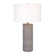 Uttermost Monolith gray table lamp with a modern, sculptural design, featuring a cylindrical base and fabric shade.