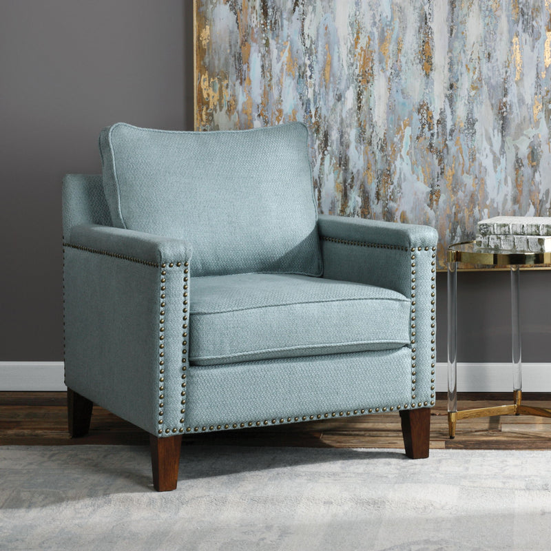 Uttermost Charlotta accent arm chair in Sea Mist fabric with wooden legs, featuring a stylish, cushioned design for modern living spaces.