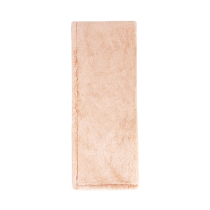 Classic Home Taiga throw blanket with textured fabric in neutral tones, perfect for cozying up on the sofa.