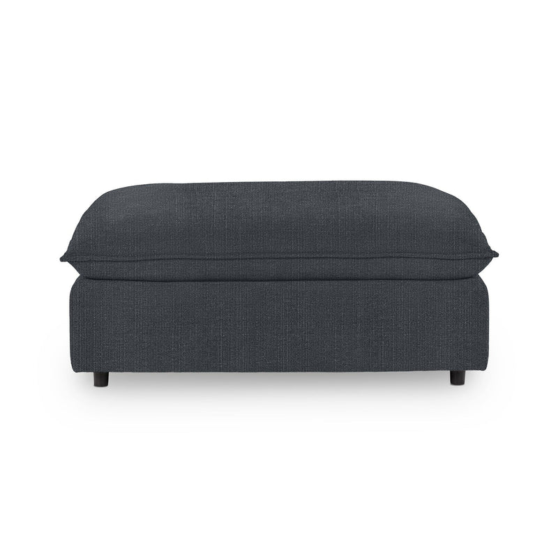 Classic Home Caplan upholstered ottoman with a plush fabric covering, serving as a stylish footrest or accent piece.