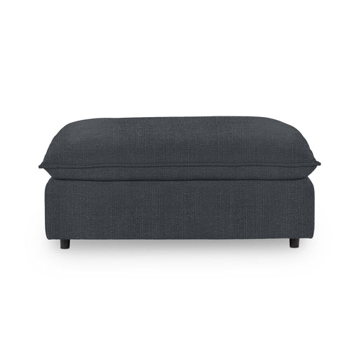 Classic Home Caplan upholstered ottoman with a plush fabric covering, serving as a stylish footrest or accent piece.