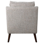 Uttermost O'Brien armchair with plush fabric, modern design, and wooden legs, showcased in a cozy living room setting.