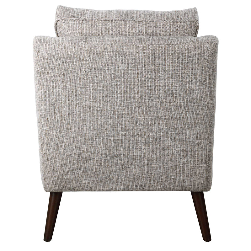 Uttermost O'Brien armchair with plush fabric, modern design, and wooden legs, showcased in a cozy living room setting.