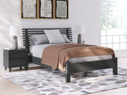 Signature Design by Ashley Danziar slat panel bed with low footboard in dark wood finish, showcasing its sleek and modern design.