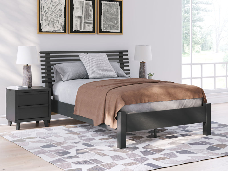 Signature Design by Ashley Danziar slat panel bed with low footboard in dark wood finish, showcasing its sleek and modern design.